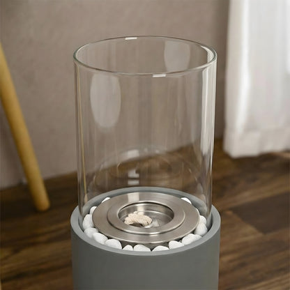 Détail du brûleur et des galets décoratifs de la cheminée éthanol cylindrique Calora Home